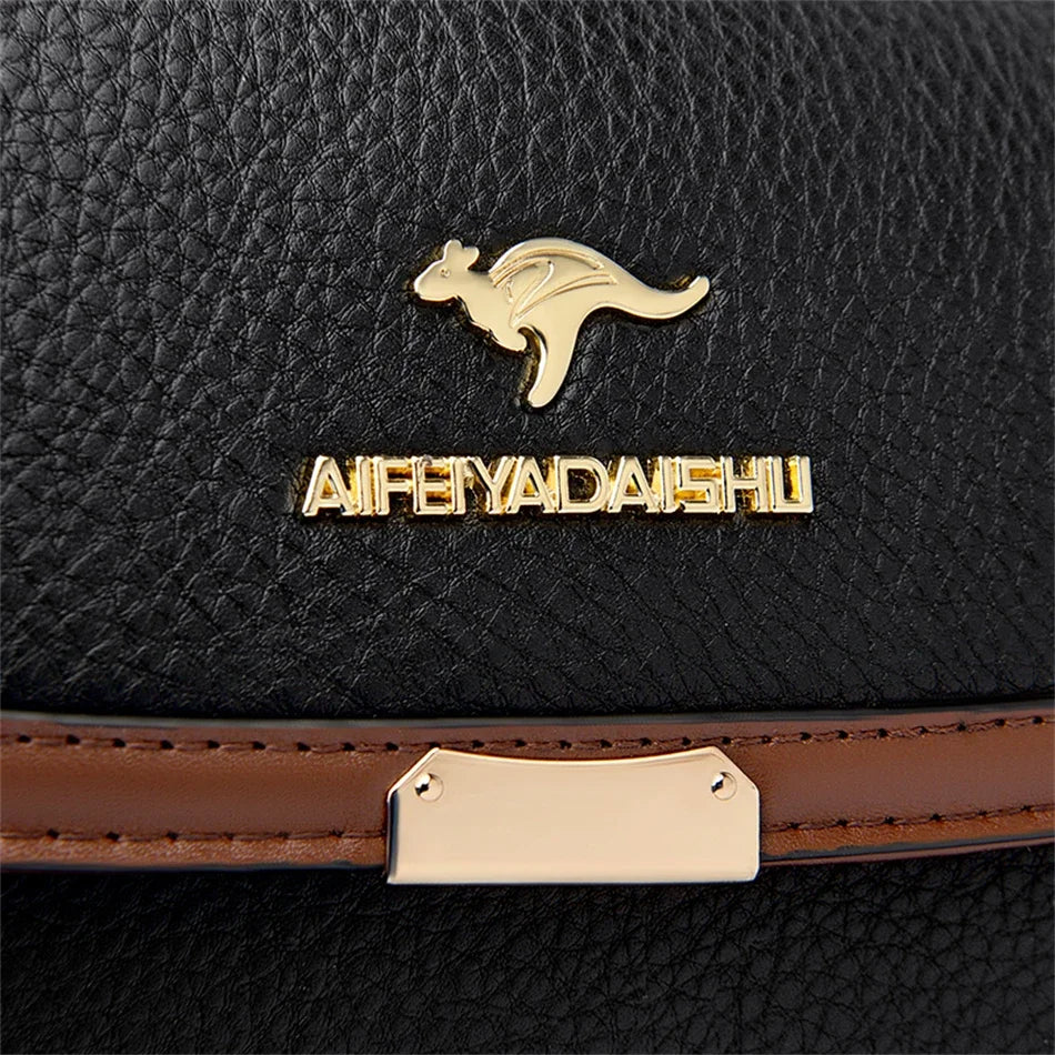 Black leather handbag with gold logo and text on a dark background