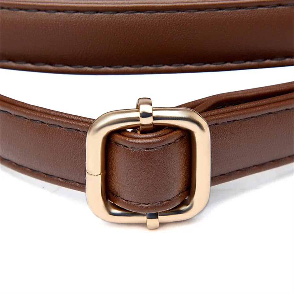 A close-up of a brown leather belt with a square-shaped gold-tone metal buckle, shown on a clean white background.