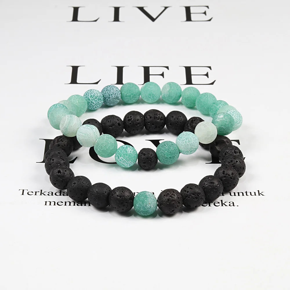 Set of black and green beaded bracelets on a white background with text.