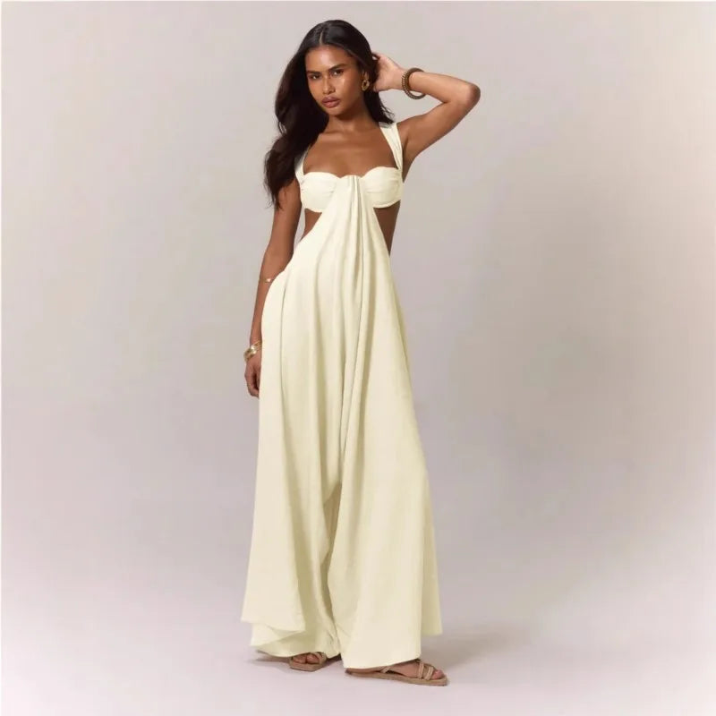 Woman wearing a strapless, long, light-colored dress against a plain background