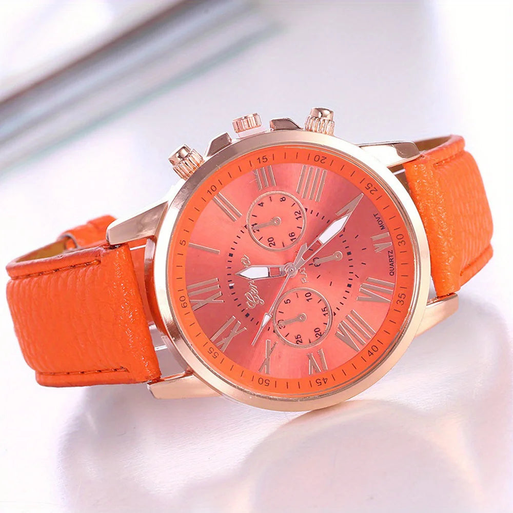Orange watch with a gold strap on a white background