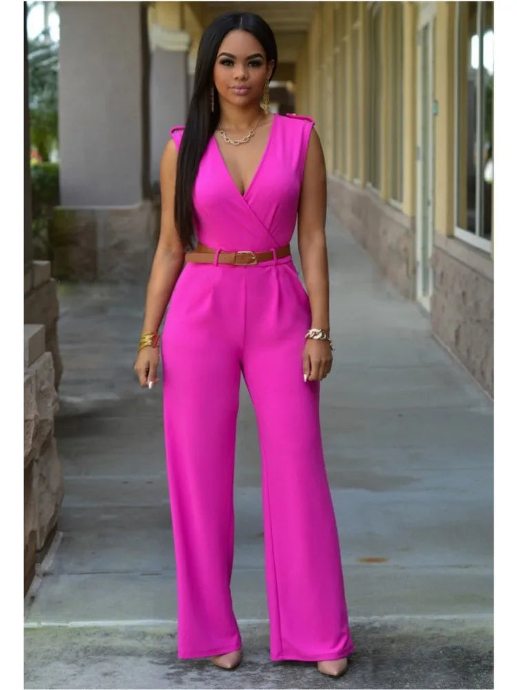A woman wearing a sleeveless, belted, wide-leg jumpsuit in pink.