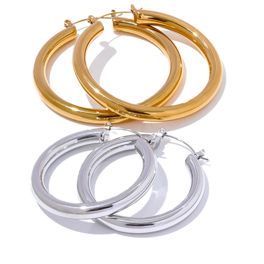 Gold and silver hoop earrings on a white background with 'Yup' branding.