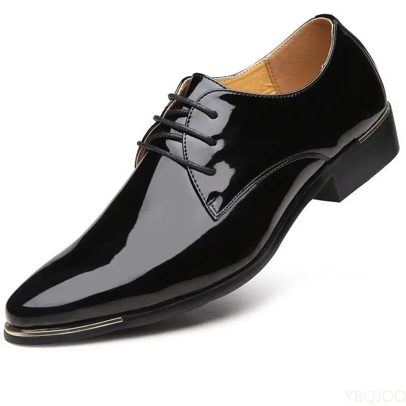 Black patent leather dress shoe on a white background