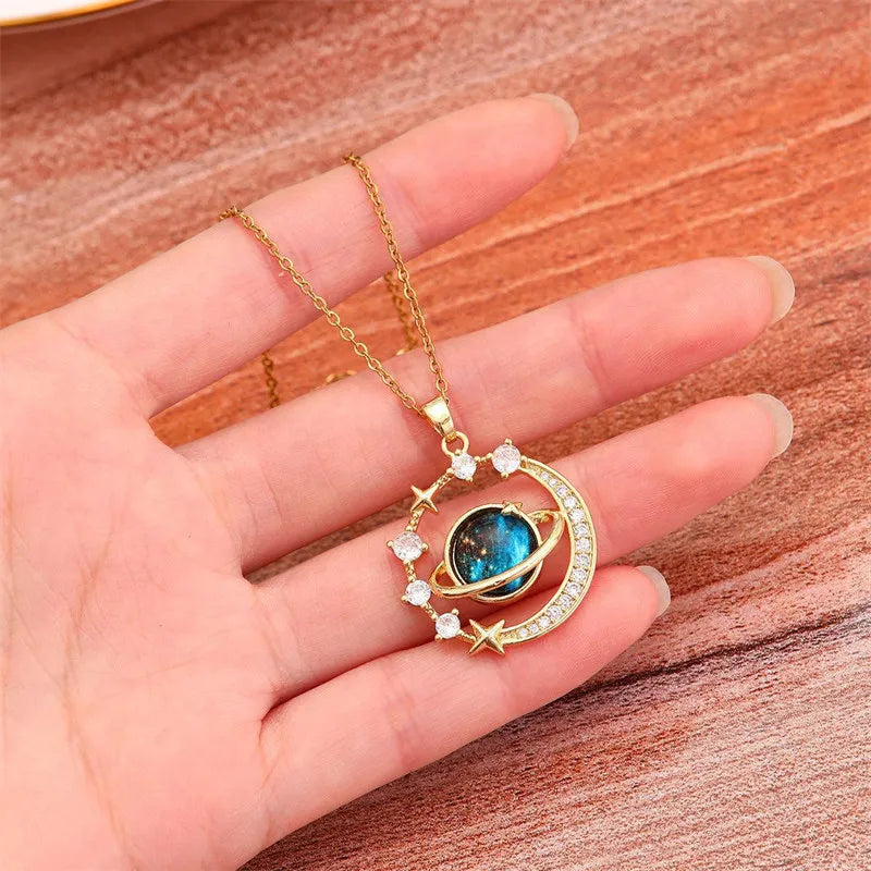 Gold necklace with a blue gemstone pendant on wooden surface