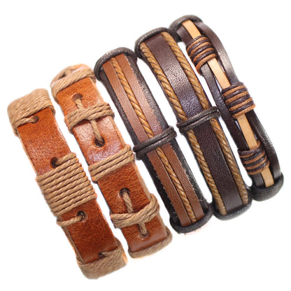Set of leather bracelets with brown and black straps on a white background