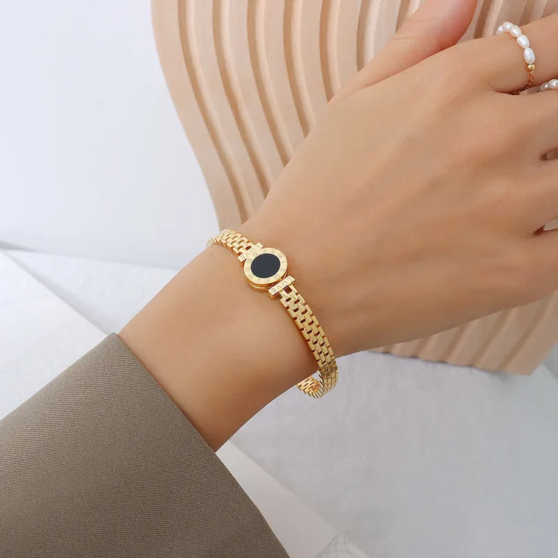 Gold bracelet with a black stone for a casual elegant look.