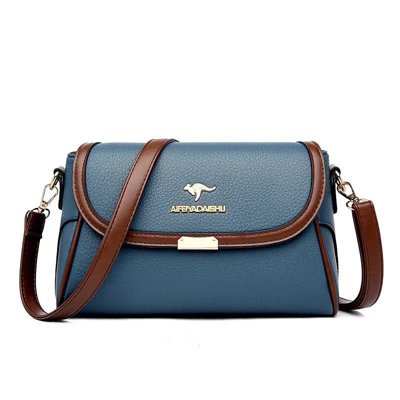 Blue handbag with brown strap and visible brand logo on a white background