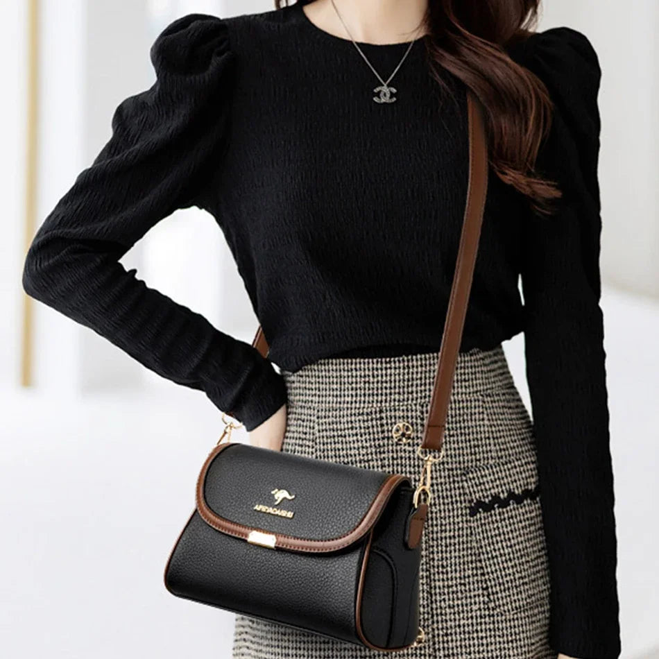 Person wearing a black sweater and plaid skirt with a black handbag on a white background