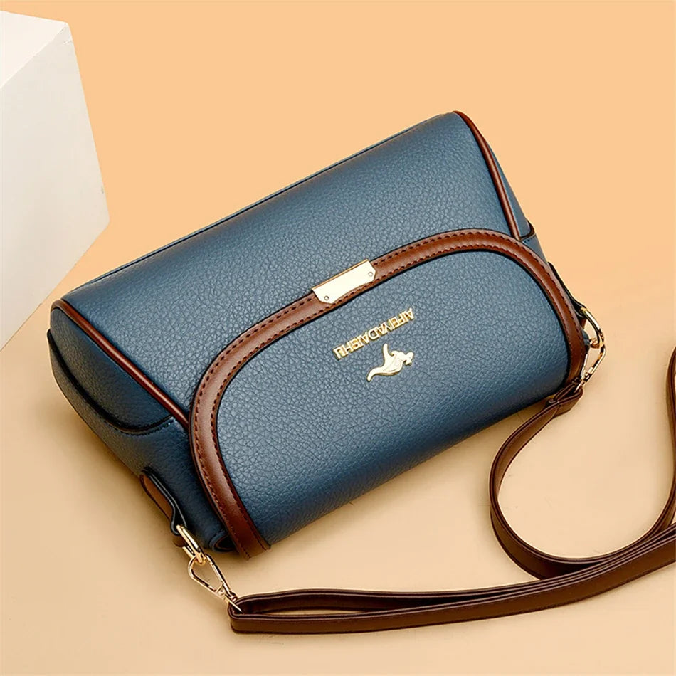 Blue handbag with brown strap on a beige background