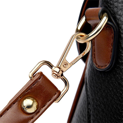 Close-up of a brown leather strap with gold hardware on a black textured background
