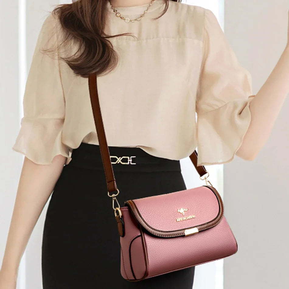 Person holding a pink handbag with a visible brand logo against a neutral background