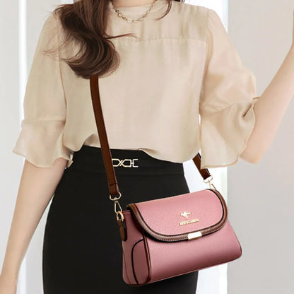 Person holding a pink handbag with a visible brand logo against a neutral background