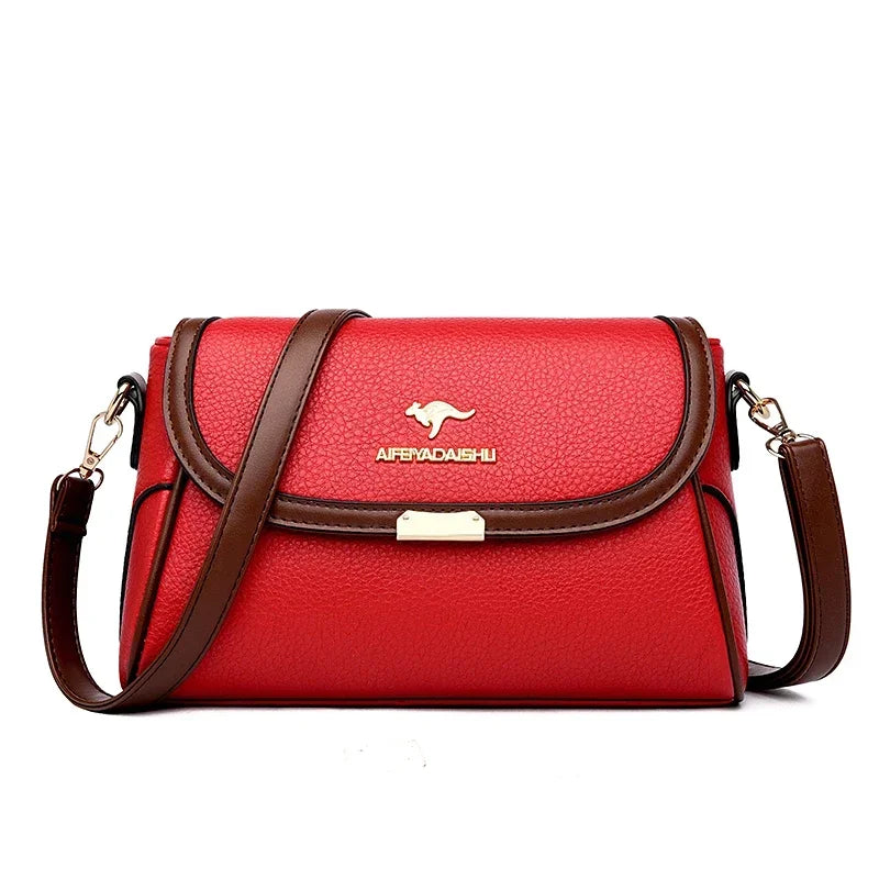 Red handbag with brown accents and a visible brand logo on a white background