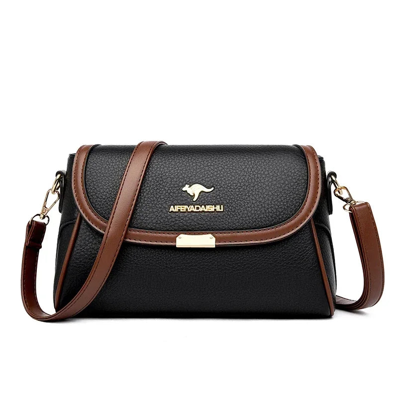 Black handbag with brown accents and a visible brand logo on a white background