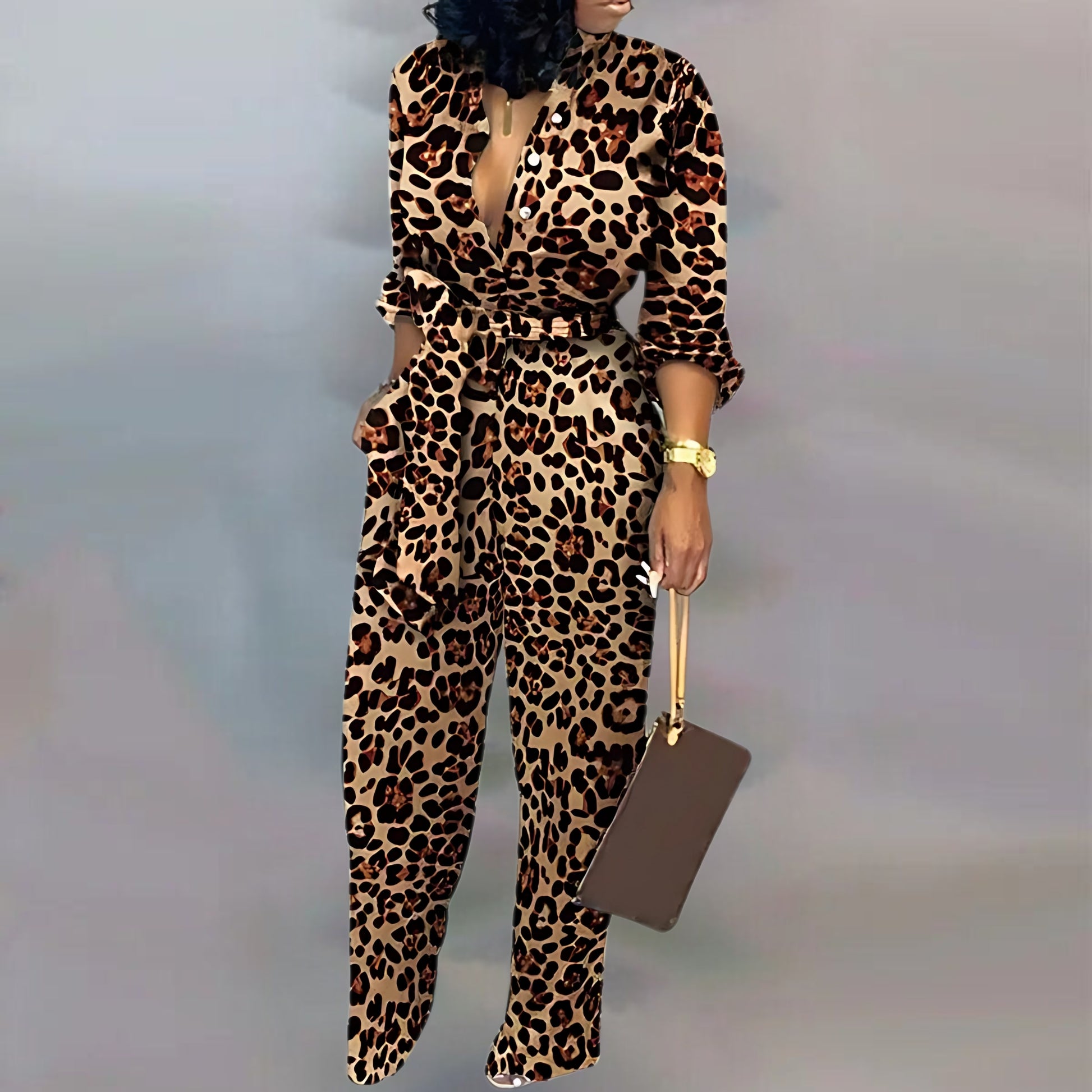  A fashionable leopard-pattern jumpsuit with rolled-up sleeves, a plunging neckline, and a belted waist. The outfit is paired with a brown rectangular bag, metallic heels, and a gold watch.