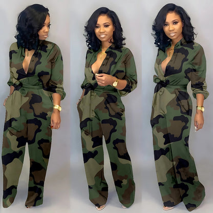 Three images of a person wearing a green camouflage jumpsuit styled with a tie belt and a plunging neckline. The accessories include a gold watch and a necklace, with open-toe heels adding a subtle touch of elegance. The person’s curled hair and confident expressions are consistent across the poses.