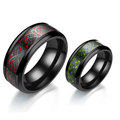 Two black-rimmed rings with red and green inlays on a white background