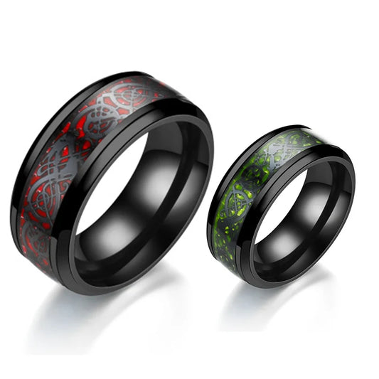 Two black-rimmed rings with red and green inlays on a white background