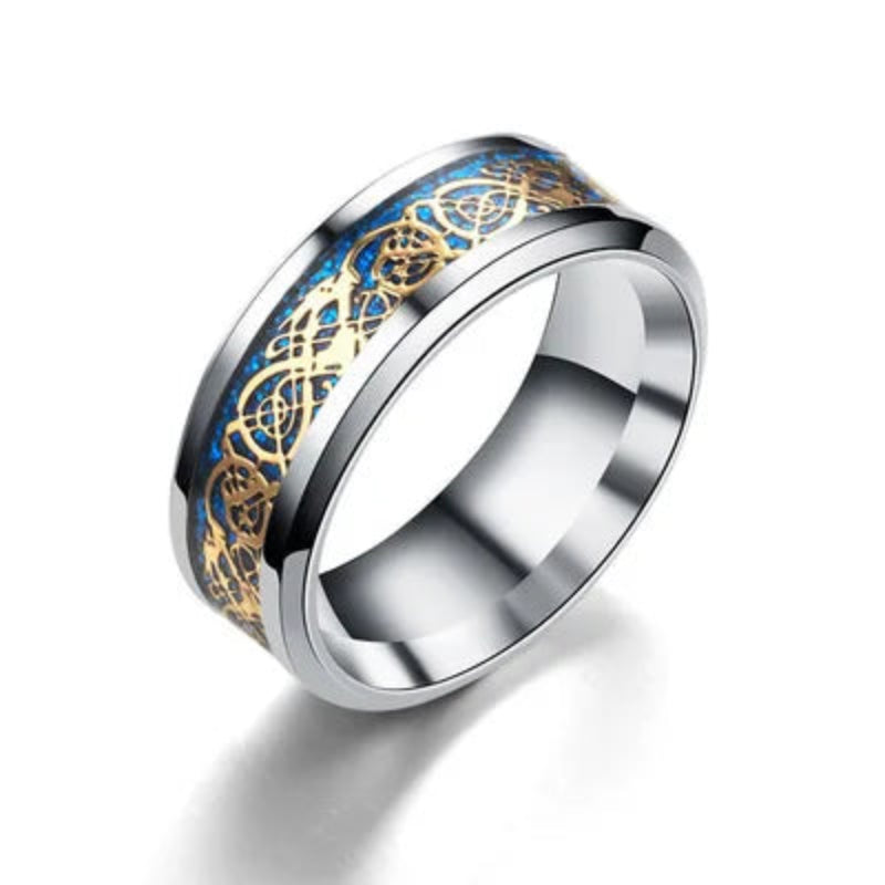 Silver ring with blue and gold inlay on a white background