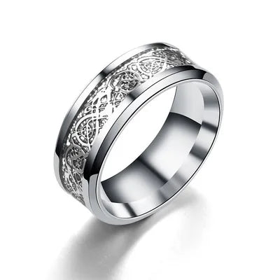 Silver ring with intricate design on a white background
