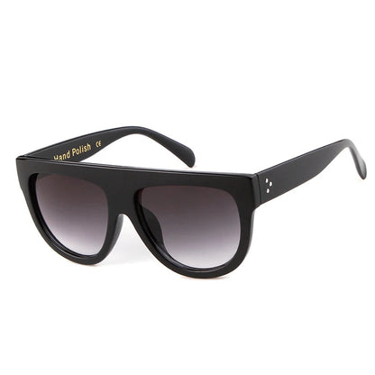Black sunglasses with gradient lenses on a white background, branded 'Who Cutie'.
