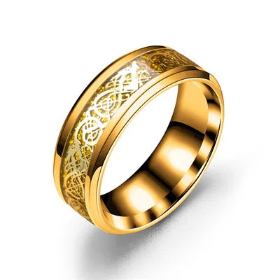 Gold ring with intricate design on a white background