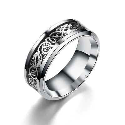 Silver ring with intricate design on a white background