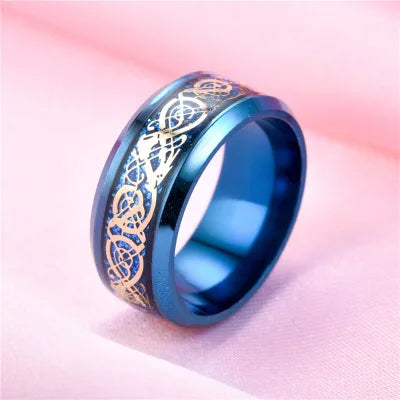 Blue ring with gold intricate design on a pink background