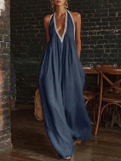 Woman wearing a blue dress with lace details in an indoor setting.