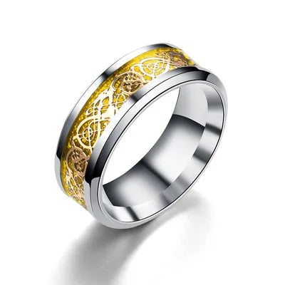Silver ring with gold Celtic knot design on a white background