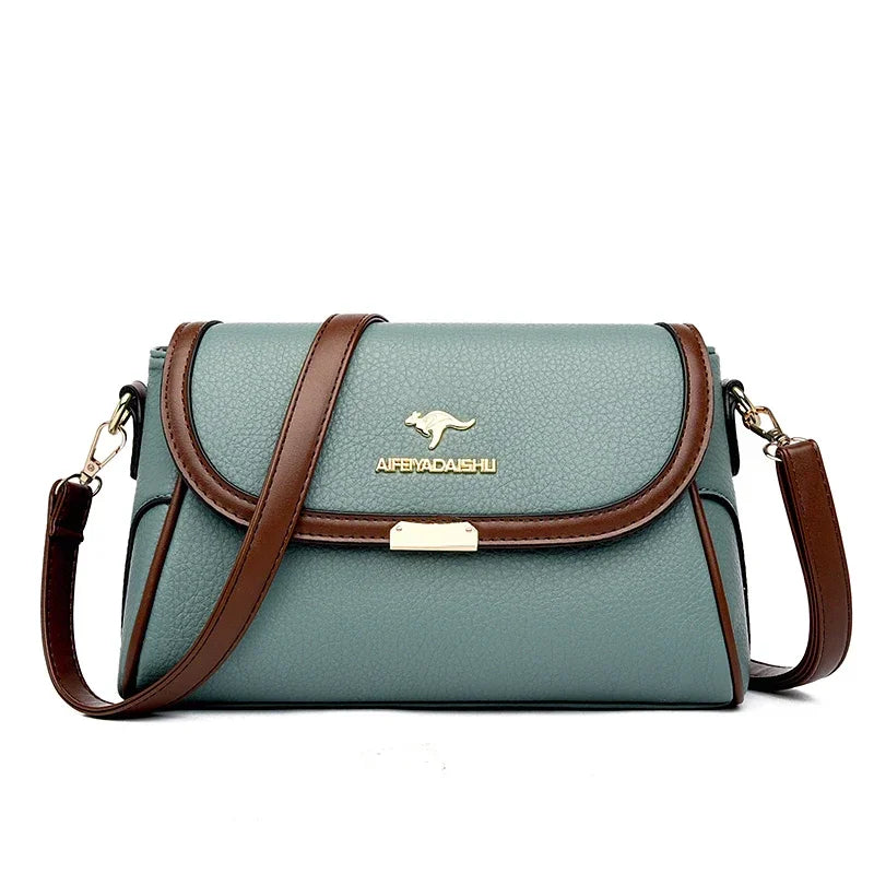 Green handbag with brown straps and a visible brand logo on a white background