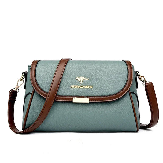 Green handbag with brown straps and a visible brand logo on a white background