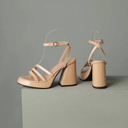 Beige high-heeled sandals on a gray background