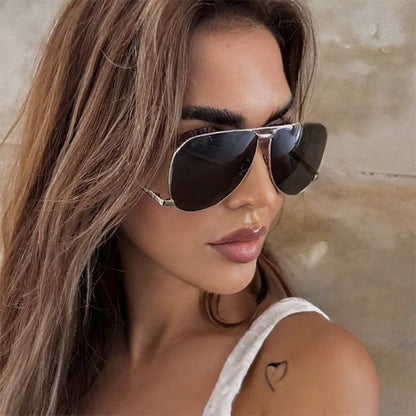 Woman wearing black sunglasses with a neutral background