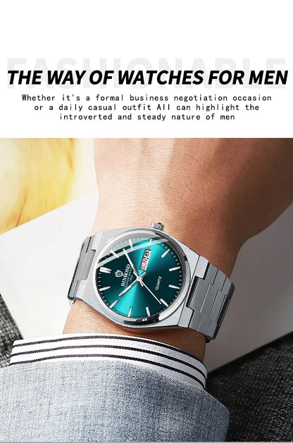 Silver watch with a green face on a person's wrist, with text about watches for men.