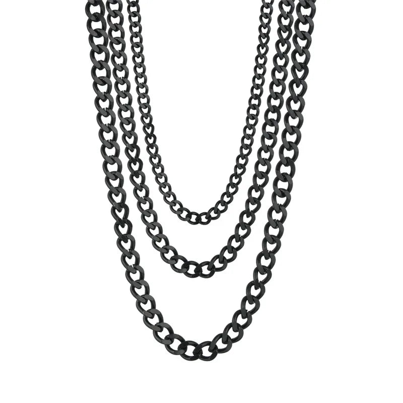Three layered black metal curb chains of varying lengths, arranged in a cascading drape on a plain white background.