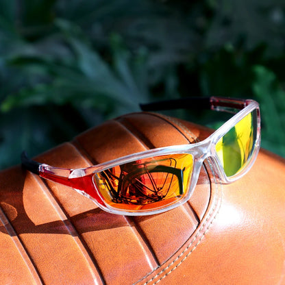 Sunglasses with reflective lenses on a brown leather surface with a blurred green background