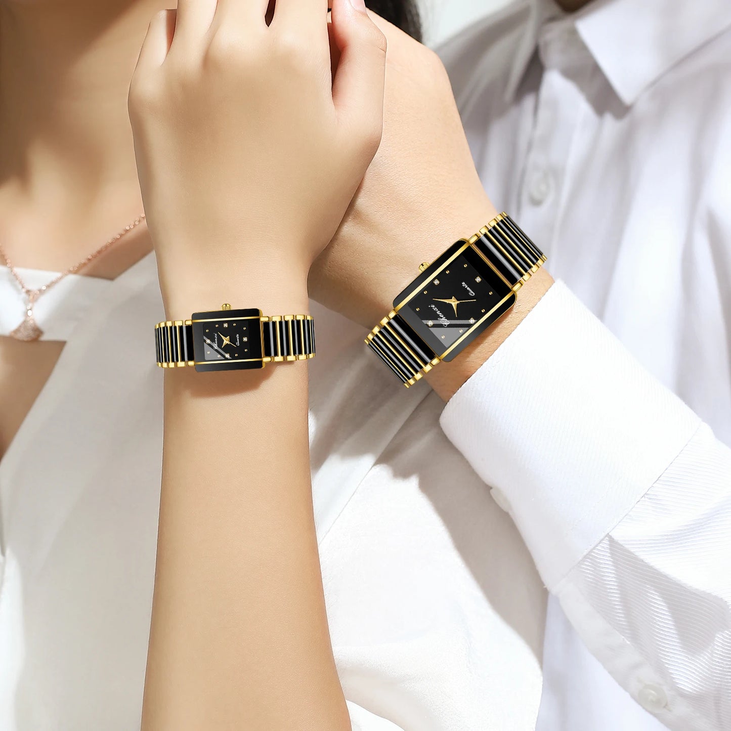 Two wrists wearing black and gold rectangular watches against a white background