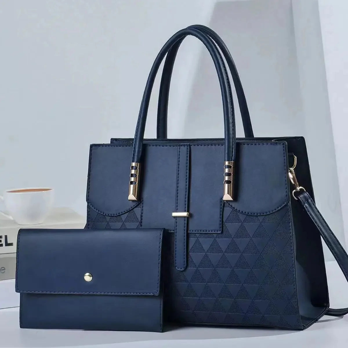 Blue handbag with matching wallet on a light gray background
