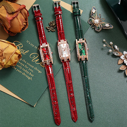 Two watches with red and green straps on a green surface with decorative elements.