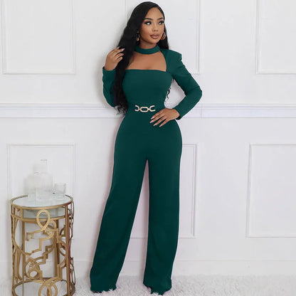 Woman wearing a green jumpsuit with a white wall background