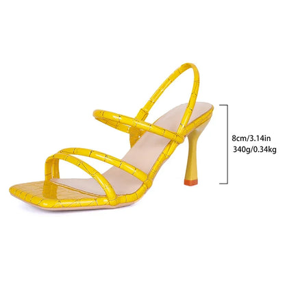 Yellow high-heeled sandal with measurements on a white background
