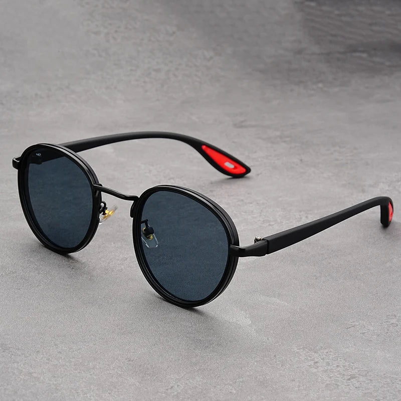 Retro round sunglasses with black frames, dark grey lenses, and black temple arms