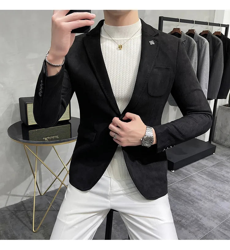 Person wearing a black blazer over a white sweater in a clothing store.