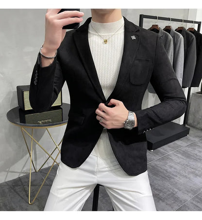 Person wearing a black blazer over a white sweater in a clothing store.