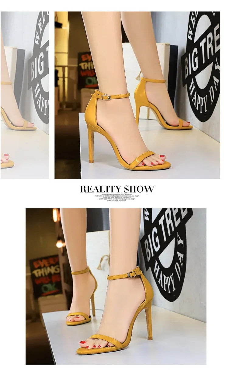 Yellow high-heeled shoes being worn with a minimal background