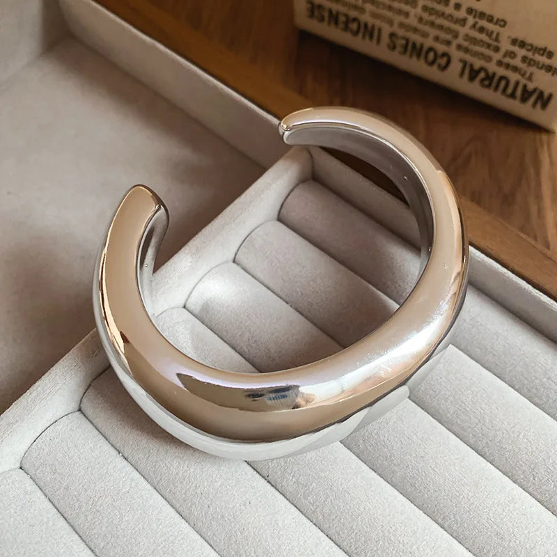 Silver ring on a soft, textured surface with a blurred background