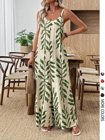 Woman wearing a green leaf-patterned jumpsuit in a dining room setting.