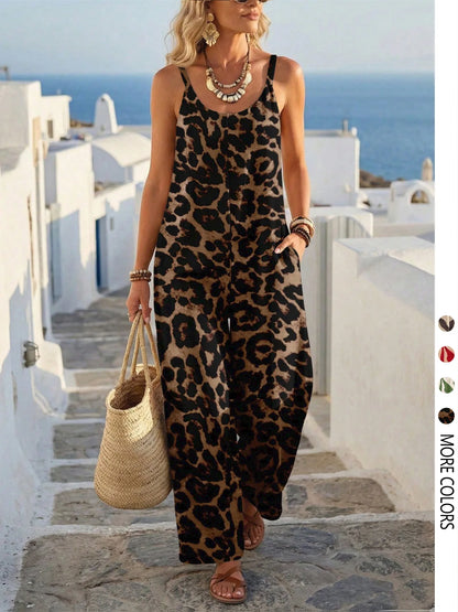 Woman in a leopard print dress standing on a Mediterranean-style street with white buildings and blue sky.